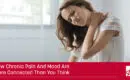 header image for blog a woman holds her shoulder with a pained expression on her face the caption says how chronic pain and mood are more connected than you think