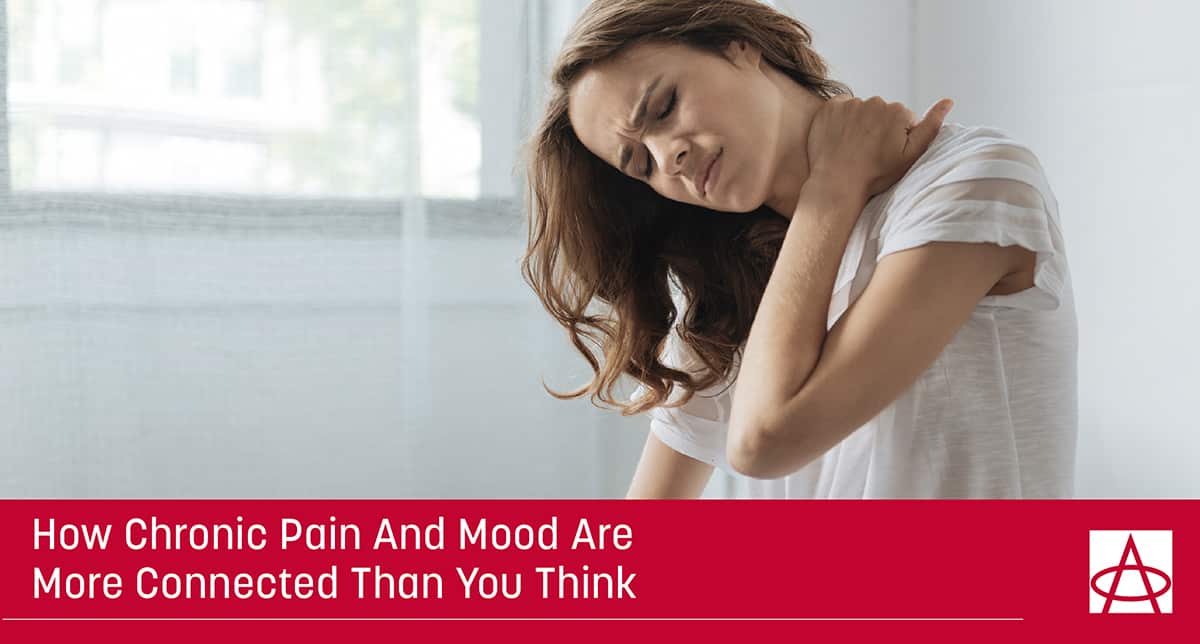 header image for blog a woman holds her shoulder with a pained expression on her face the caption says how chronic pain and mood are more connected than you think