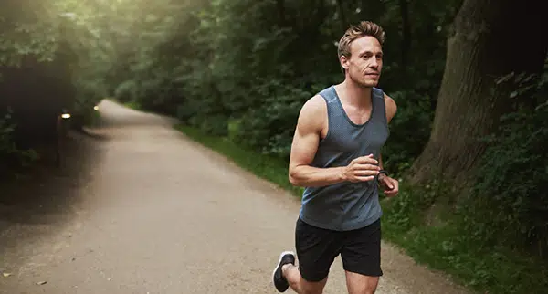 a man is jogging through the park