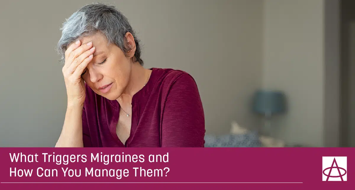 A woman rubs her forehead because of migraine pain